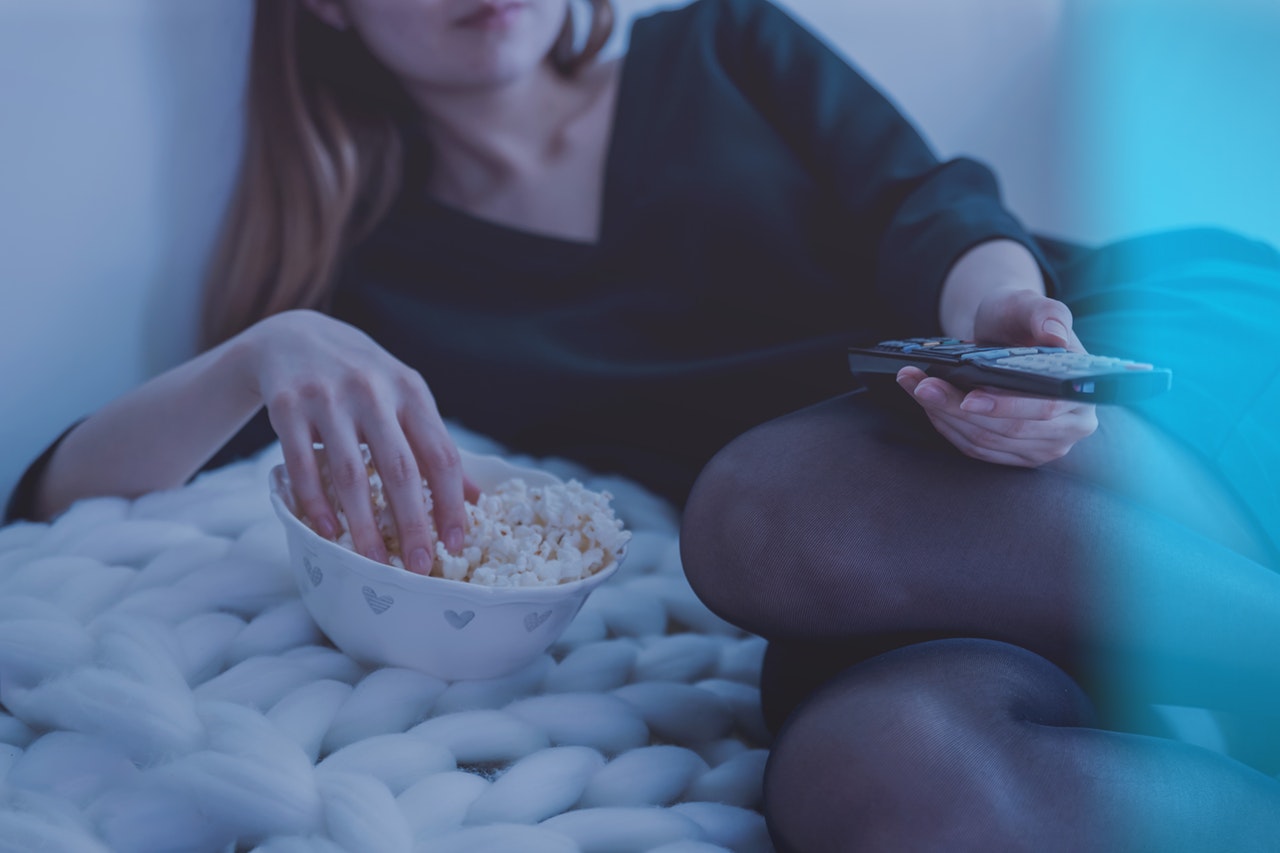 Lady watching TV on bed